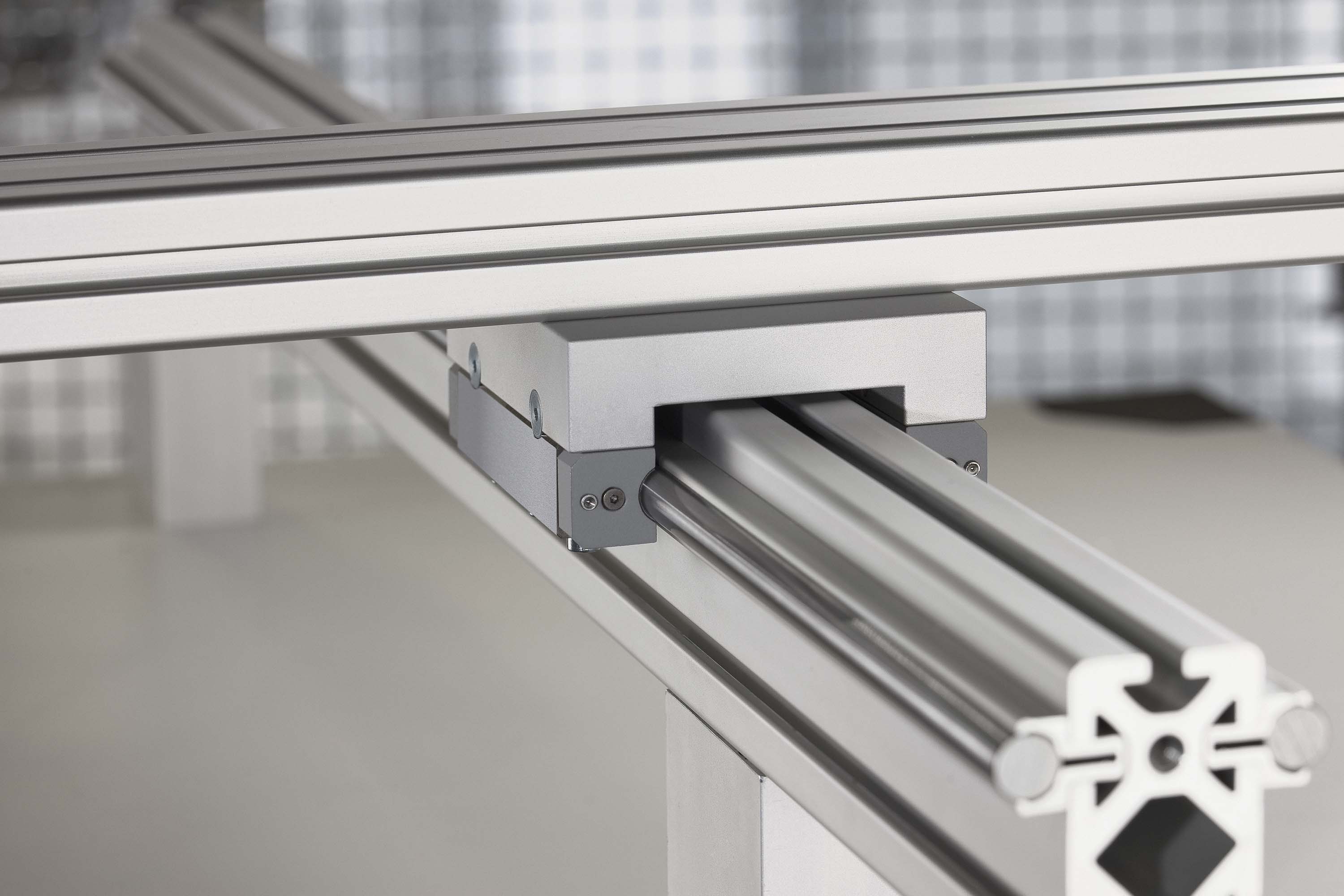 Example of a linear unit with a recirculating ball-bearing guide. The carriage moves on a slide mounted on ball bearings that runs along a profiled rail. Ball bearings are the usual type of rolling element used, and they run along a line between the rail and slide. This type of linear guide is especially rigid and strong.