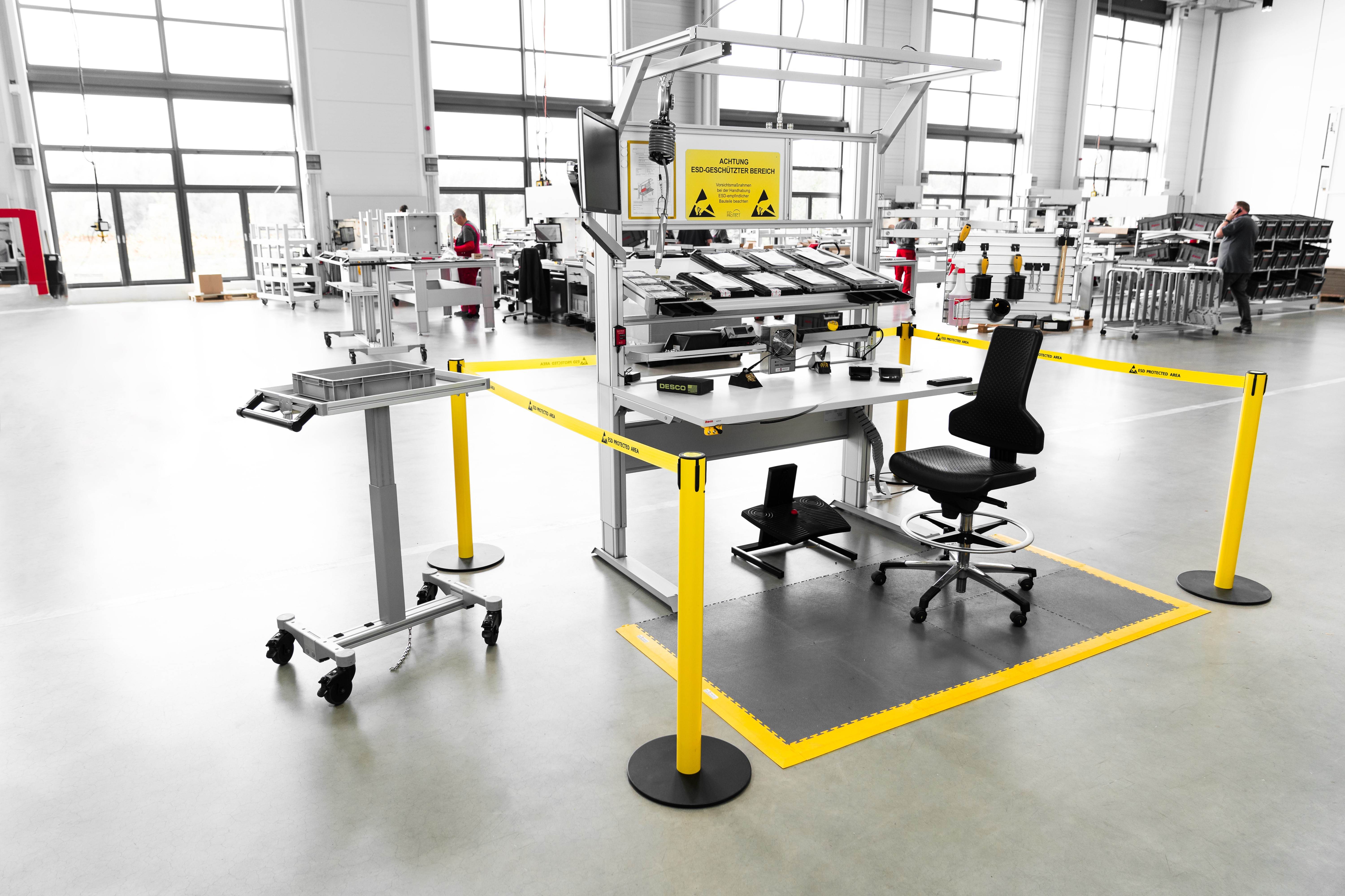 Work bench with comprehensive ESD protection. The zone marked in yellow is the electrostatic protected area (EPA). The EPA is a zone in which all equipment is earthed to the same electrical potential. Electrostatically dissipative table tops, special ESD accessories and earthing terminals reliably protect sensitive electronic components against uncontrolled electrostatic discharges.